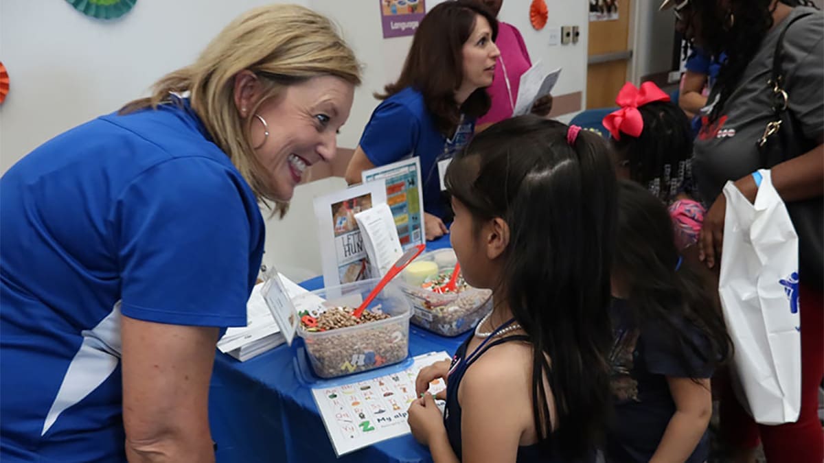 A child visiting a booth at the Kickoff to Kindergarten event.