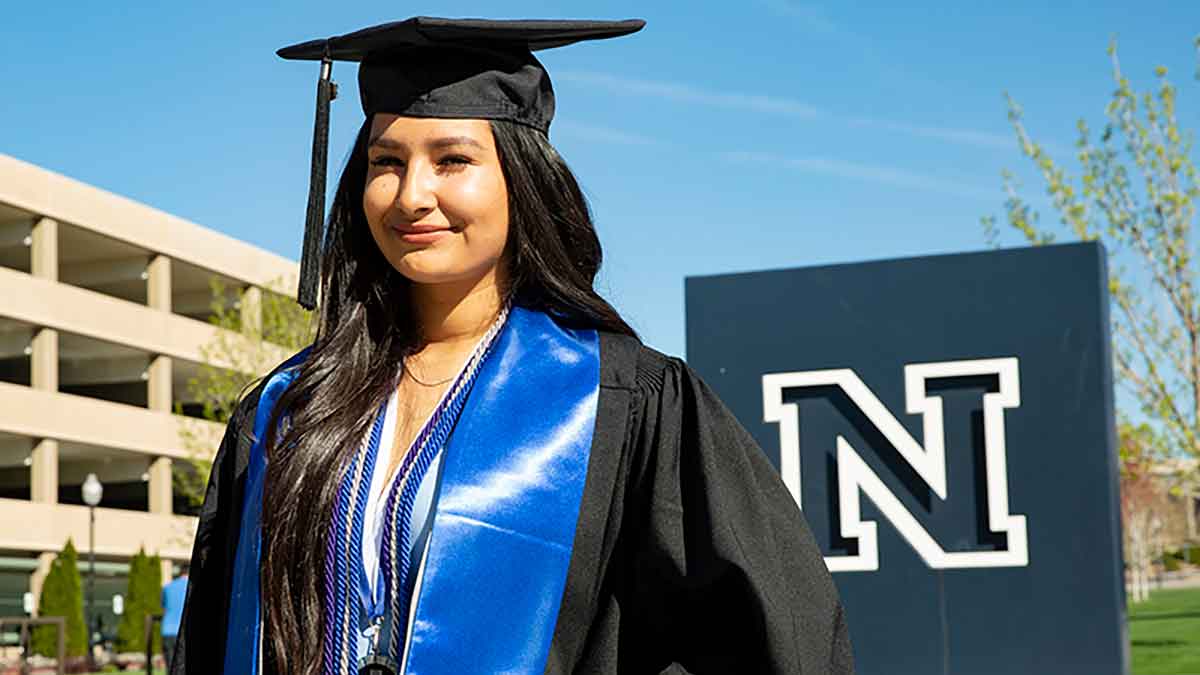 Lizeth Acosta in cap and gown and with cords