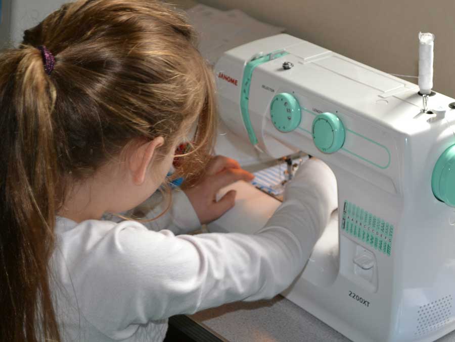 A girl using a sewing machine