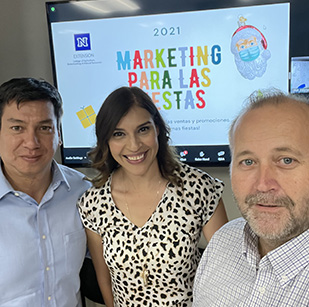 Business instructors posing in front of a screen.