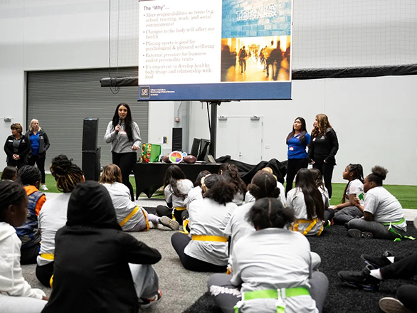 A group of adults presenting information to youth.