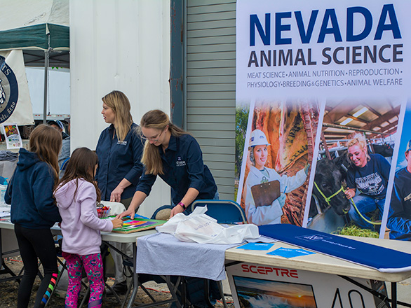 Animal science students working with kids