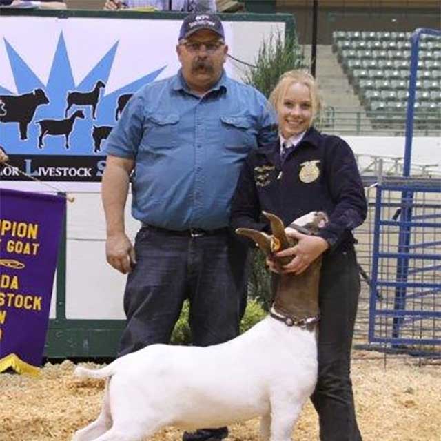 Matt McKinney with an FFA'er and her goat