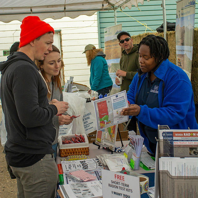 Nevada Radon Education leader showing visitors a radon brochure