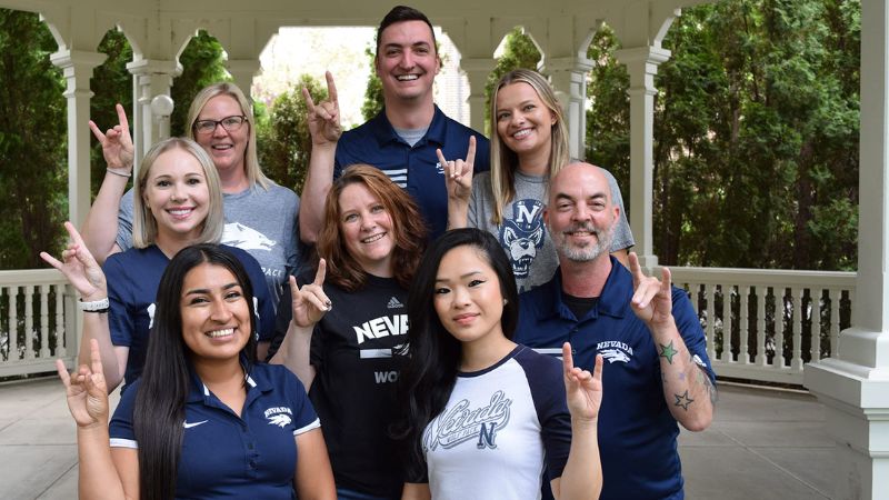 Public Health Advisors wearing UNR shirts and smiling. 