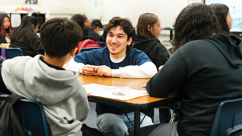 Teacher talking to students.