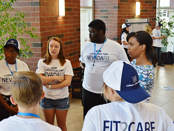 Students standing in a circle talking