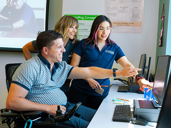 Group of students in a brightly lit classroom with mobile robotic student