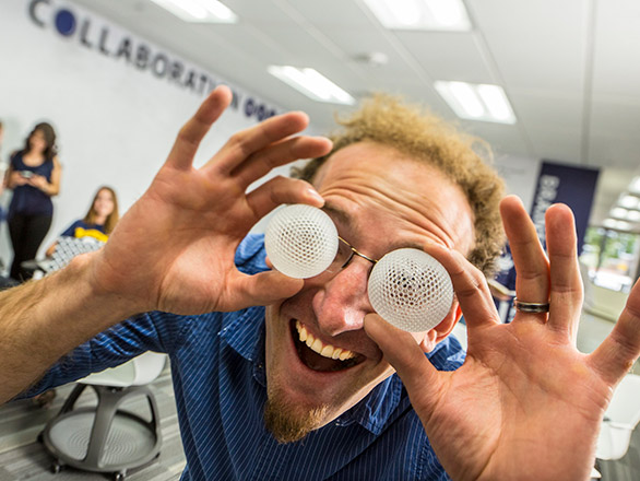 Science teacher holding up demonstration on their face to mimic eye balls