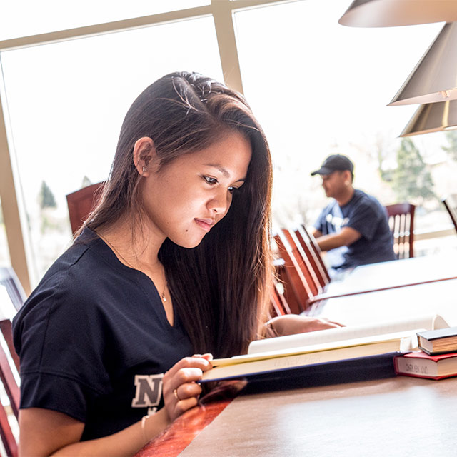 Student in the Knowledge Center reading course materials