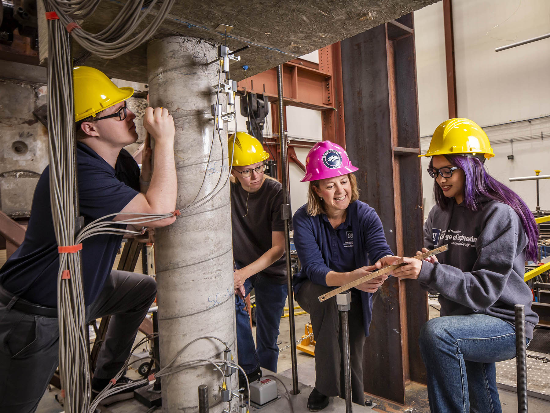 A view of the shake table lab with three tables visible and a distinct structure on each table