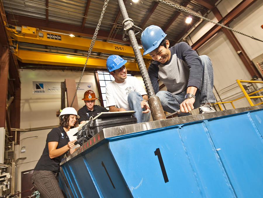 students in hard hat working on shake table