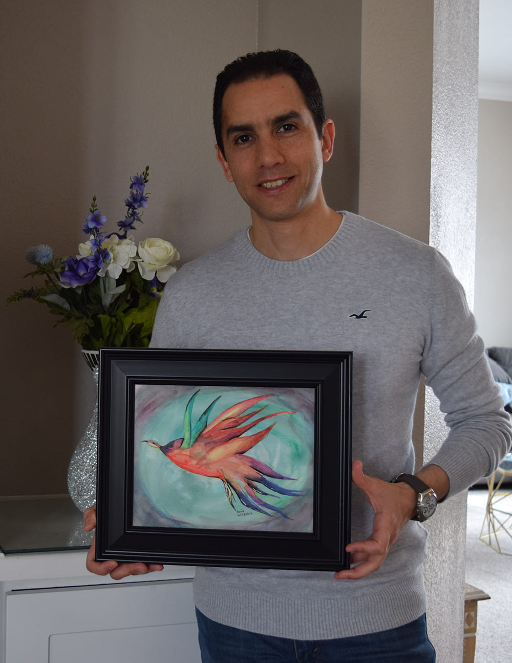 Ahmed Akl holding painting