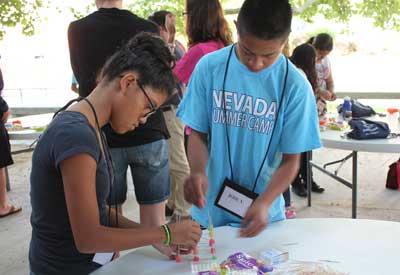 Two students work on a gumdrop structure at MESA camp