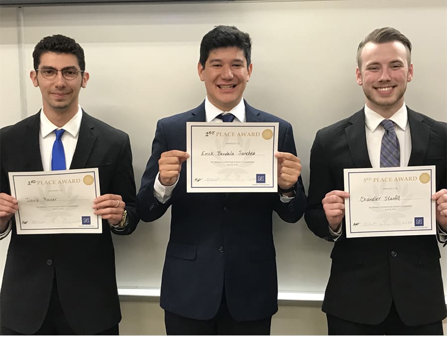 Three winners standing in a row holding certificate awards. From left, David Reiner, second place; Erick Bandala Sanchez, first place; and Chandler Stanfill, third place
