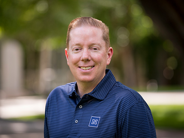 Head shot of man standing outside
