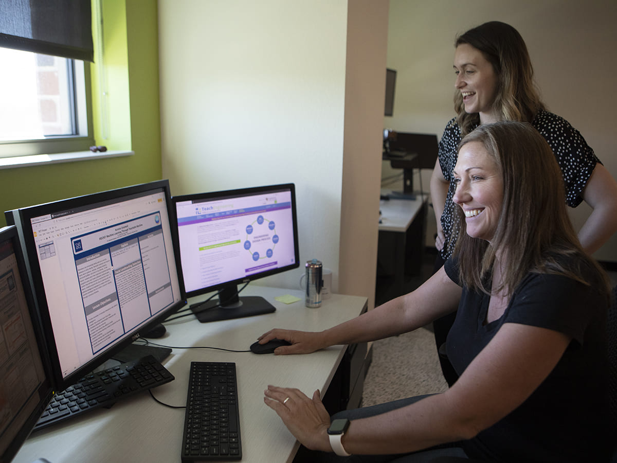 Student and professor working in computer lab