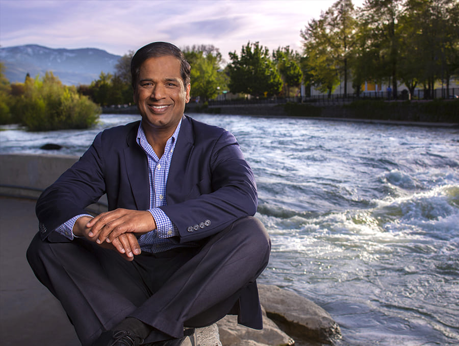 Krishna Pagilla sitting next to the Truckee River