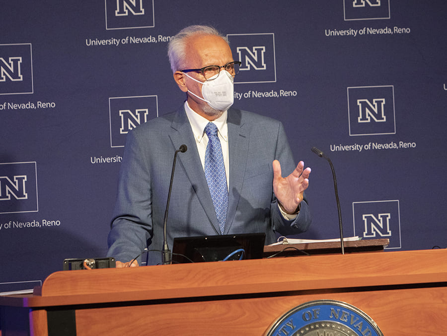 Manos Maragakis wearing face mask at podium
