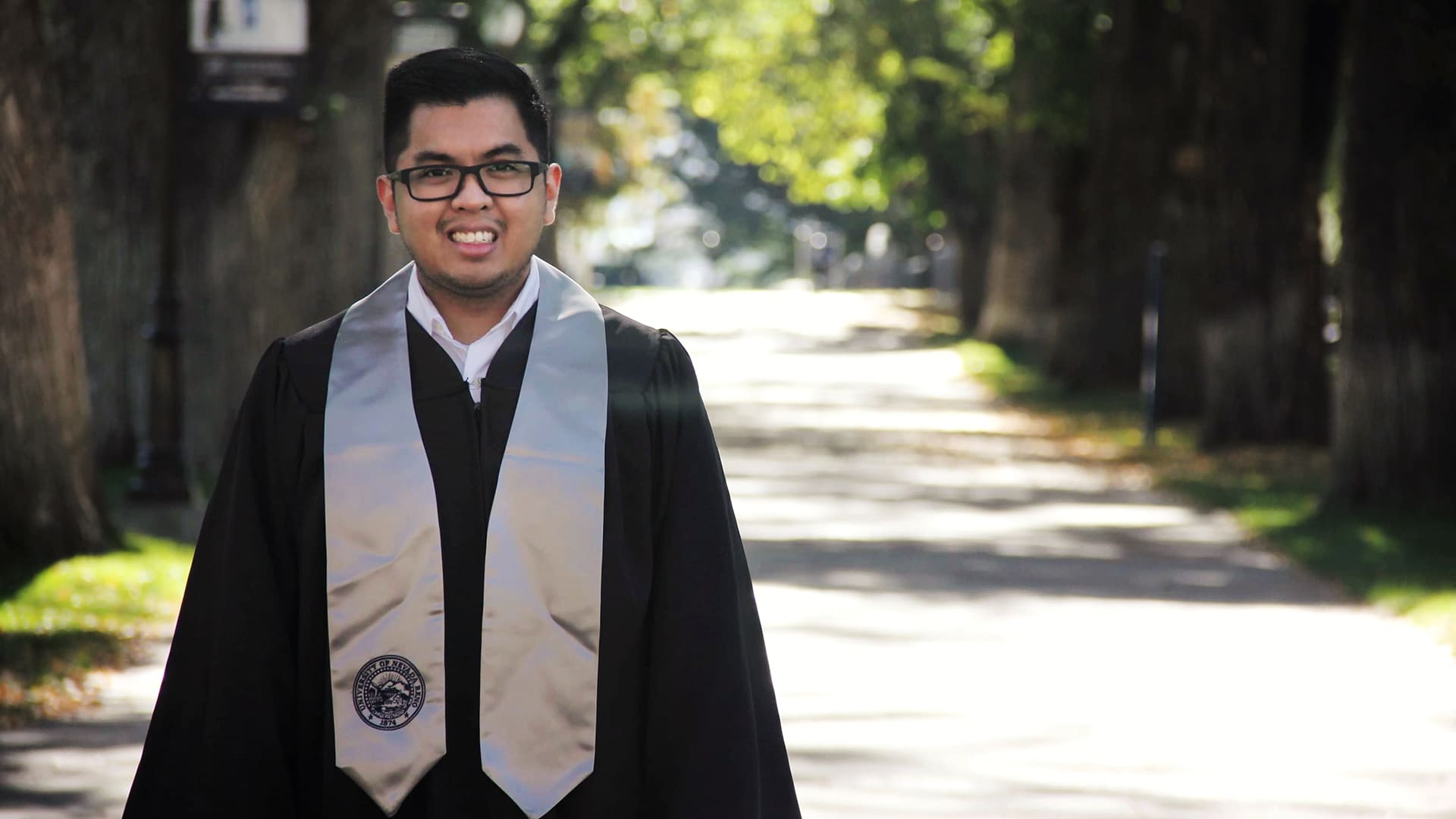 Allan Romero in graduation regalia
