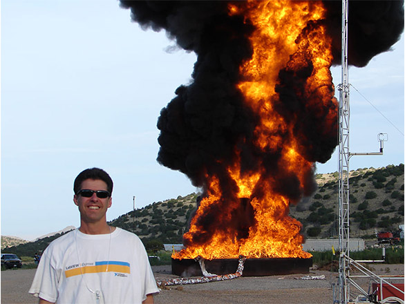 Person standing in front of large-scale fire