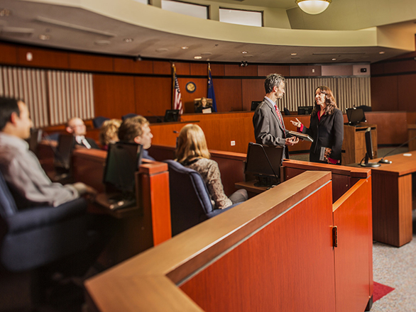 Judge and lawyer chatting while jury watches