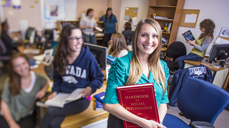 Graduate students in Social Psychology holding books and materials