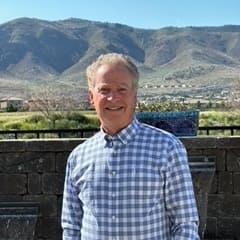 image of Arnie Glassberg in front of a mountain view.