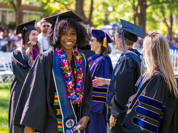A student smiles at commencement.