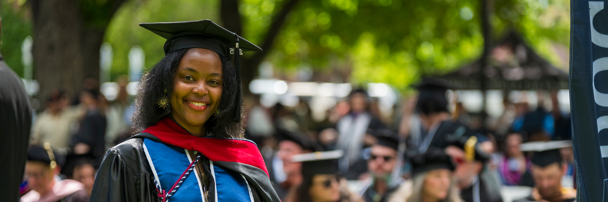 A graduate student at their commencement ceremony. 