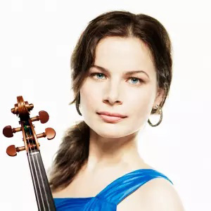 Bella Hristova poses for a headshot while holding a violin.