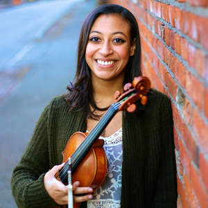 Headshot of Carmen Lavada Johnson Pájaro holding a violin.
