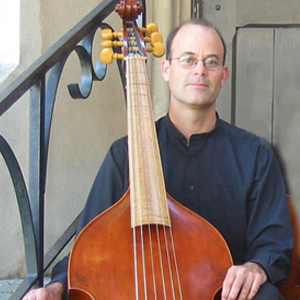 Headshot of Farley Pearce posing with a bass