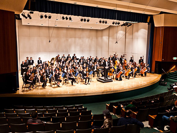 Patrons watch orchestral performers on stage at the Nightingale Concert Hall on the University of Nevada, Reno campus.