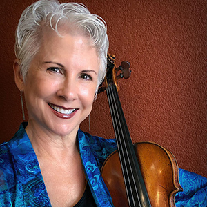 Stephanie Sant'Ambrogio poses for a headshot while holding a violin.