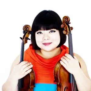 Yura Lee poses for a headshot holding a viola and violin.