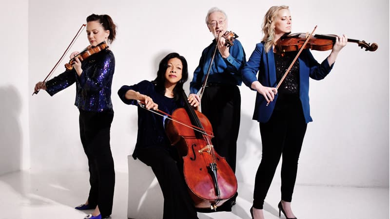 The members of the Juilliard String Quartet pose with their instruments for a publicity photo.