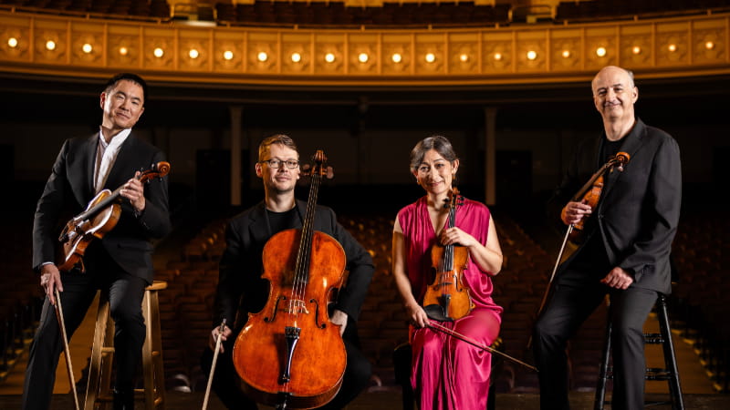 four musicians holding instruments