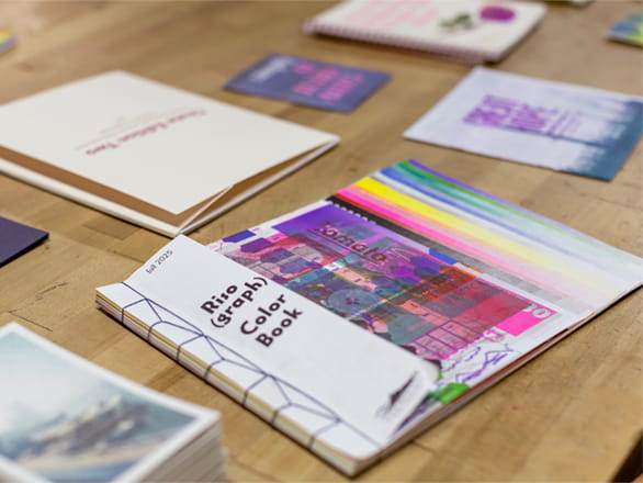 Professor examines student's book art project