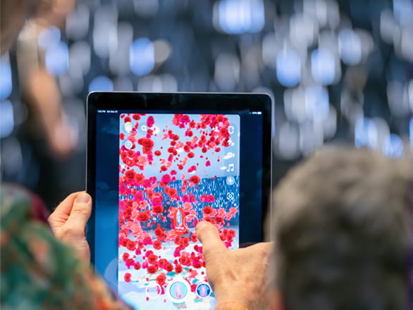 personal holding ipad playing game
