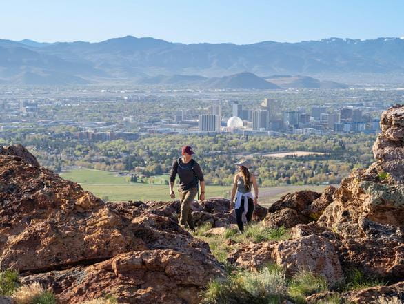 students drawing on notepads with city of Reno in the background