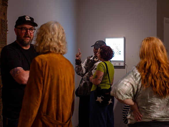 students and faculty meeting in art gallery
