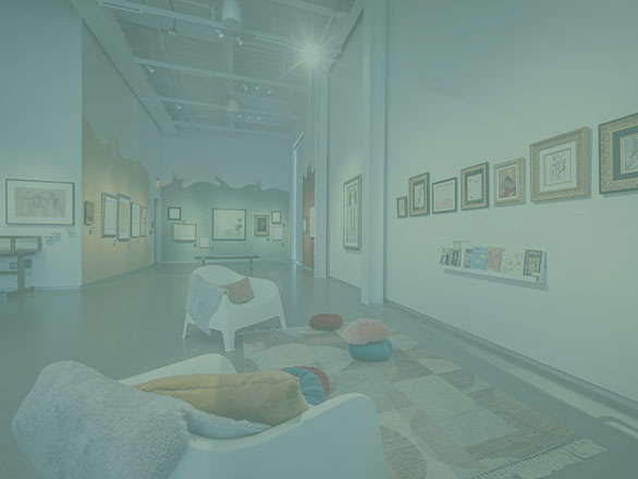 Leonor Fini exhibition with chairs and pillows on the floor facing museum wall with artwork