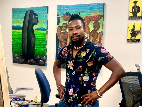 man standing with hands on hips in art room