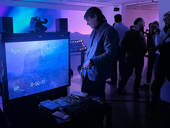 people looking at art exhibit of digital screen