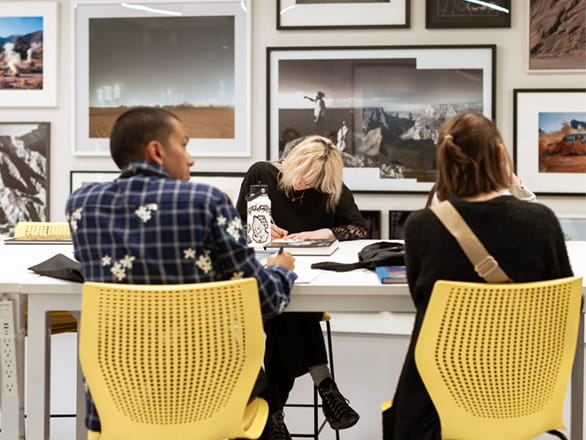 students sitting in yellow chairs at desk