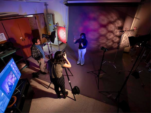 Woman stands behind camera to snap photo