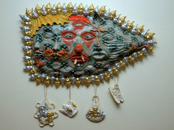 art piece with blue sculpture coated in gold pieces