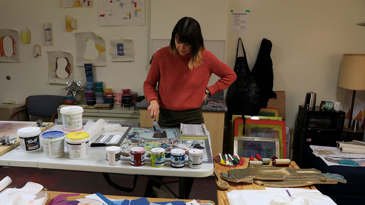 A student painting in a studio