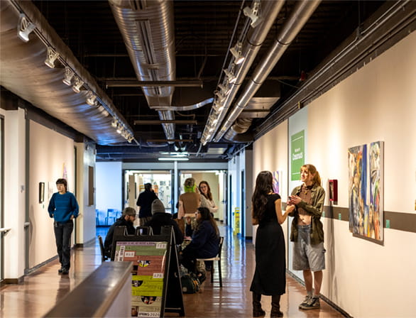people standing in hallway of art gallery